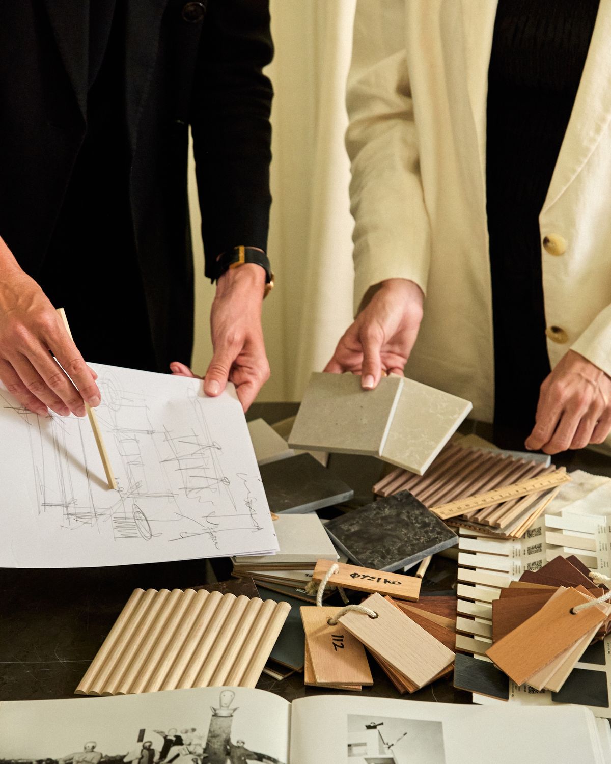 A consultation: plans and samples on a table